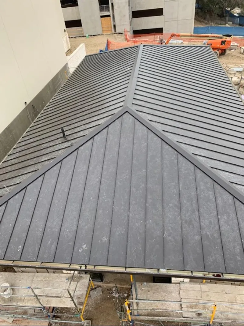 Commercial metal roof construction with crane equipment in Jennings Lodge